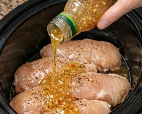 Pour italian dressing over raw chicken breasts, combined with 2 ingredients, into slow cooker for a comforting dinner that is always a yes in my house