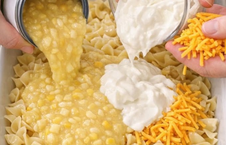 Pour cream style corn and these 2 ingredients over uncooked egg noodles into a casserole dish for a hearty dinner that families request weekly.