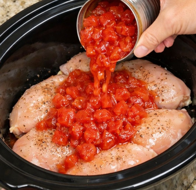 Pour canned diced tomatoes over chicken breasts, together with 3 ingredients, into slow cooker for a comforting dinner that’s my default when I don’t know what to make